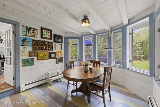 253 Upper Byrdcliffe Rd, Woodstock, NY 12498 - dining room with a baseboard radiator, plenty of natural light, light wood-type flooring, wooden walls, and wood ceiling with exposed beams