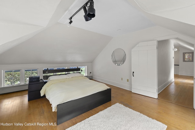 253 Upper Byrdcliffe Rd, Woodstock, NY 12498 - bedroom with lofted ceiling, hardwood / wood-style flooring, and baseboards