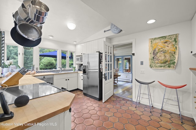 253 Upper Byrdcliffe Rd, Woodstock, NY 12498 - kitchen with stainless steel appliances, white cabinets, french doors, recessed lighting, and baseboard heating