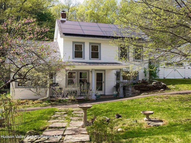 236 Spillway Rd, West Hurley, NY 12491 - view of front of property featuring roof mounted solar panels, a front yard, a chimney, covered porch, and a gate