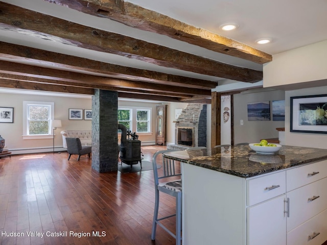 236 Spillway Rd, West Hurley, NY 12491 - kitchen featuring open floor plan, a baseboard heating unit, white cabinetry, beamed ceiling, and dark stone counters