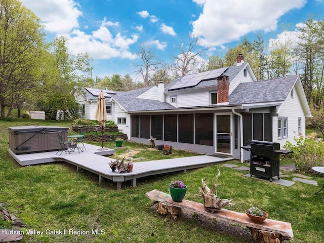236 Spillway Rd, West Hurley, NY 12491 - rear view of property with a hot tub, a sunroom, a deck, a chimney, and a yard