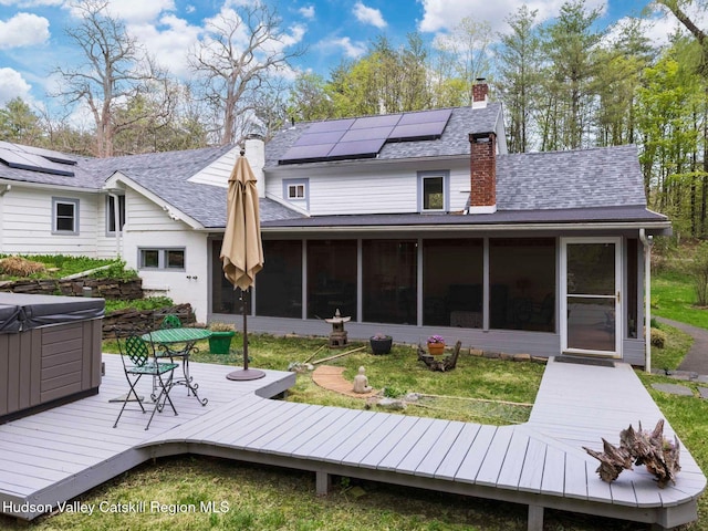 236 Spillway Rd, West Hurley, NY 12491 - back of house with a sunroom, a hot tub, a deck, and a chimney