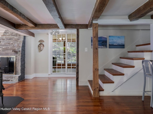 236 Spillway Rd, West Hurley, NY 12491 - unfurnished living room featuring hardwood / wood-style flooring, beamed ceiling, stairway, baseboards, and a chandelier