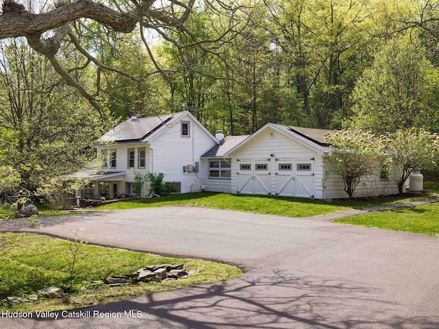 236 Spillway Rd, West Hurley, NY 12491 - view of front of house featuring driveway, a garage, and a front lawn