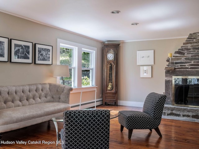 236 Spillway Rd, West Hurley, NY 12491 - living area featuring a baseboard heating unit, crown molding, wood finished floors, a fireplace, and baseboards