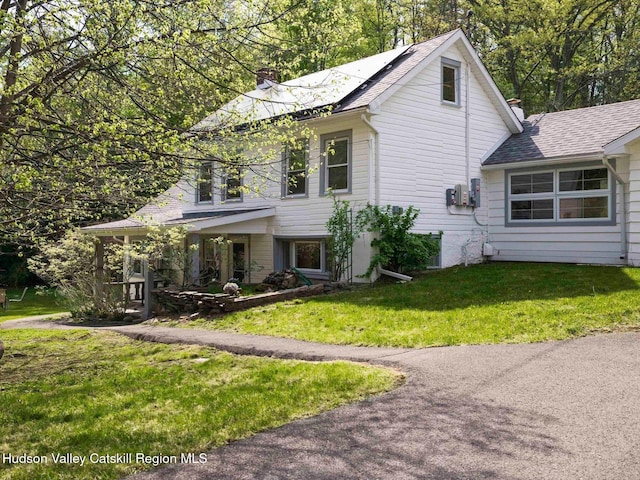 236 Spillway Rd, West Hurley, NY 12491 - view of front of home with a chimney, a front lawn, and a shingled roof
