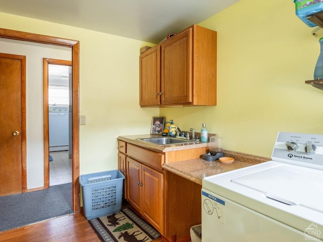 laundry room with washer / dryer, cabinet space, wood finished floors, and a baseboard heating unit