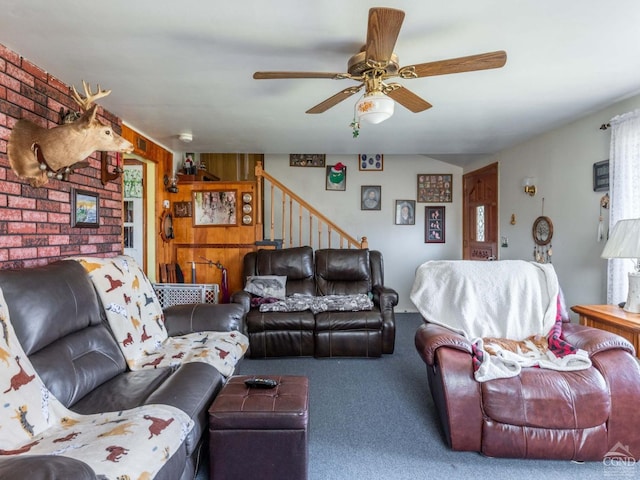 carpeted living area featuring stairway and a ceiling fan