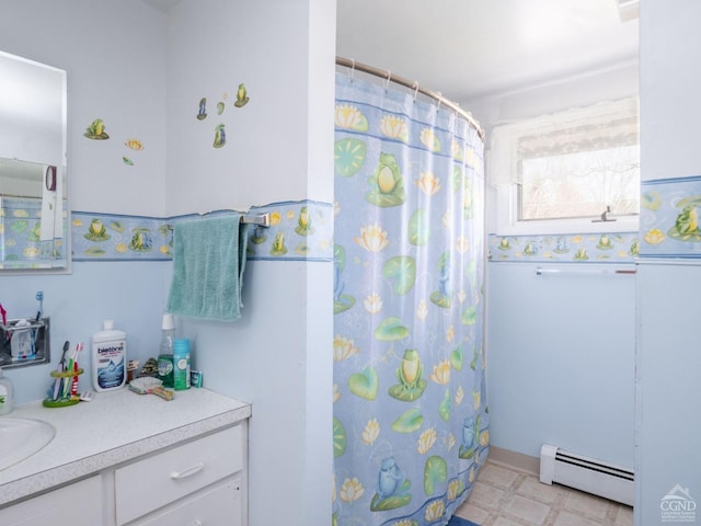 bathroom with baseboard heating, vanity, and a shower with curtain