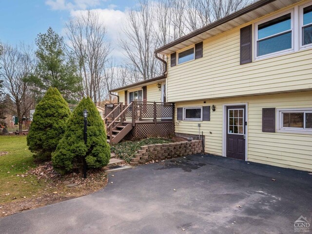 back of property featuring a patio and a wooden deck