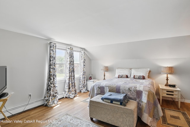 1 Huguenot Rd, Tillson, NY 12486 - bedroom featuring wood finished floors, a baseboard radiator, vaulted ceiling, and baseboards