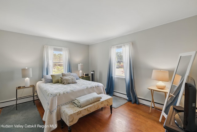 1 Huguenot Rd, Tillson, NY 12486 - bedroom featuring multiple windows, a baseboard heating unit, and wood finished floors
