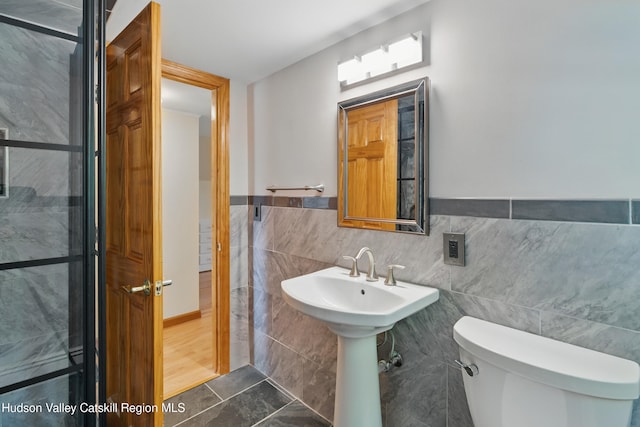 1 Huguenot Rd, Tillson, NY 12486 - half bathroom with tile walls, toilet, tile patterned floors, and wainscoting