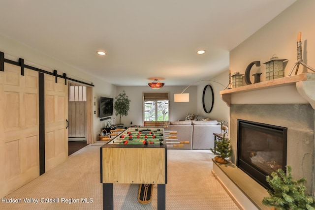 122 Brainard Ridge Rd Unit 14F, Windham, NY 12496 - game room with carpet, a barn door, recessed lighting, a glass covered fireplace, and a baseboard heating unit