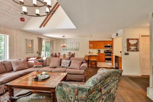 122 Brainard Ridge Rd Unit 14F, Windham, NY 12496 - living room featuring plenty of natural light, a chandelier, wood finished floors, lofted ceiling, and wine cooler