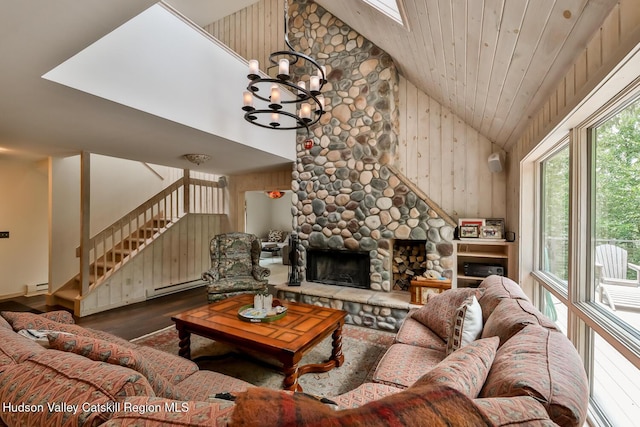 122 Brainard Ridge Rd Unit 14F, Windham, NY 12496 - living room with healthy amount of natural light, wood finished floors, a stone fireplace, high vaulted ceiling, and stairs