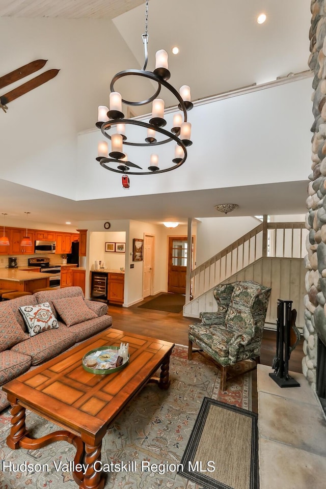 122 Brainard Ridge Rd Unit 14F, Windham, NY 12496 - living room with high vaulted ceiling, a chandelier, recessed lighting, beverage cooler, and stairway