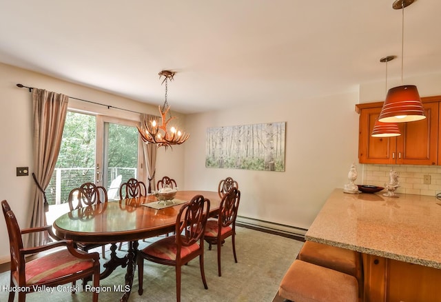 122 Brainard Ridge Rd Unit 14F, Windham, NY 12496 - dining area with a baseboard radiator and a chandelier