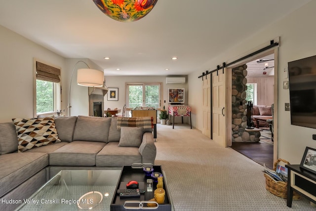 122 Brainard Ridge Rd Unit 14F, Windham, NY 12496 - carpeted living area with a barn door, recessed lighting, and a wall mounted AC