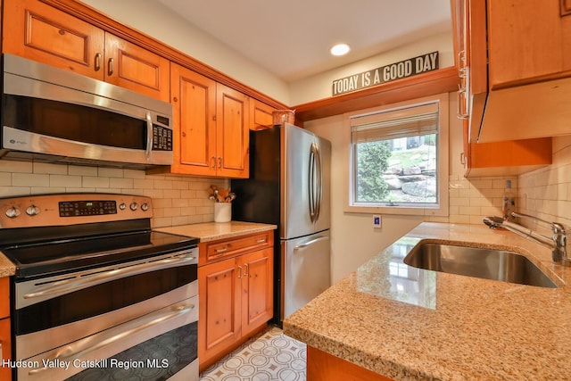 122 Brainard Ridge Rd Unit 14F, Windham, NY 12496 - kitchen with appliances with stainless steel finishes, brown cabinets, light stone countertops, and recessed lighting