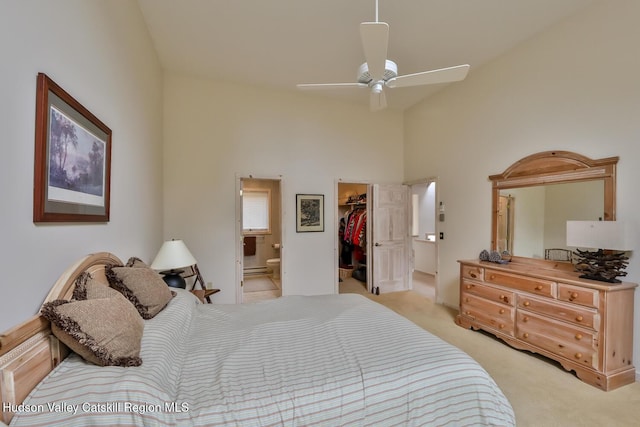 122 Brainard Ridge Rd Unit 14F, Windham, NY 12496 - bedroom featuring light colored carpet, a walk in closet, ensuite bath, and high vaulted ceiling