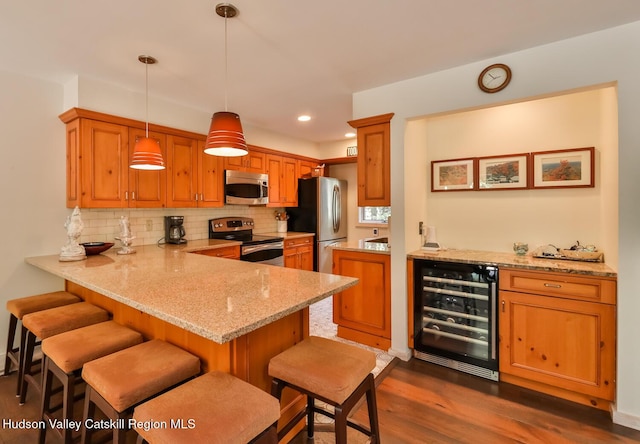 122 Brainard Ridge Rd Unit 14F, Windham, NY 12496 - kitchen featuring wine cooler, stainless steel appliances, a peninsula, dark wood finished floors, and decorative backsplash