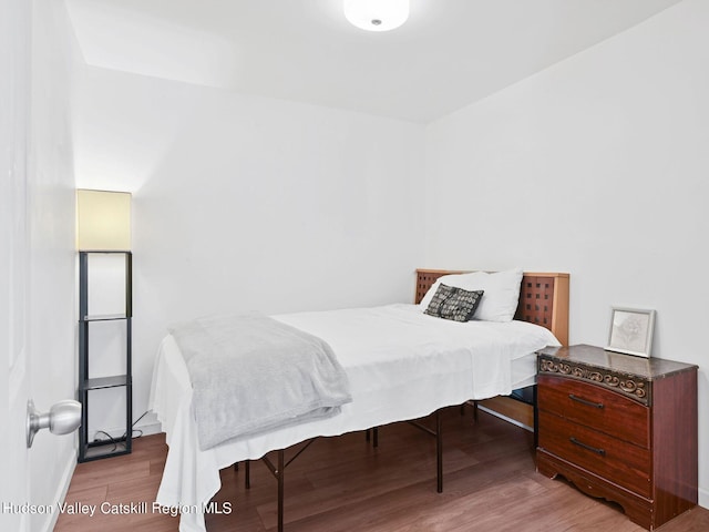 bedroom with wood-type flooring