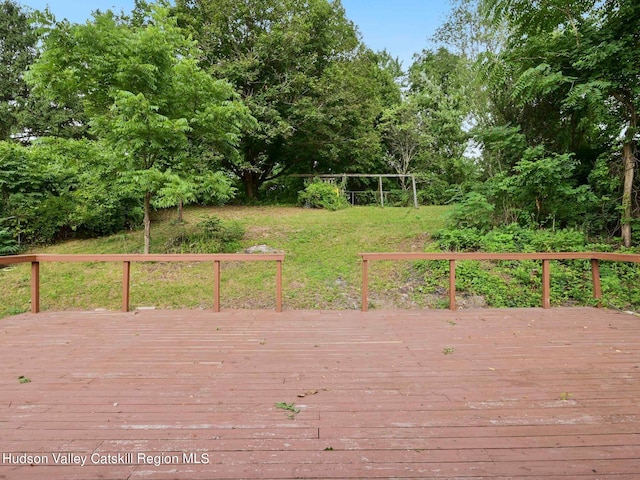 wooden deck featuring a yard