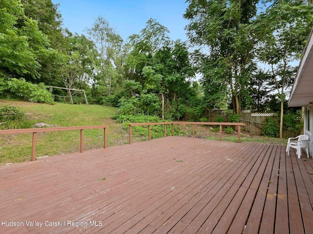 wooden terrace featuring a yard