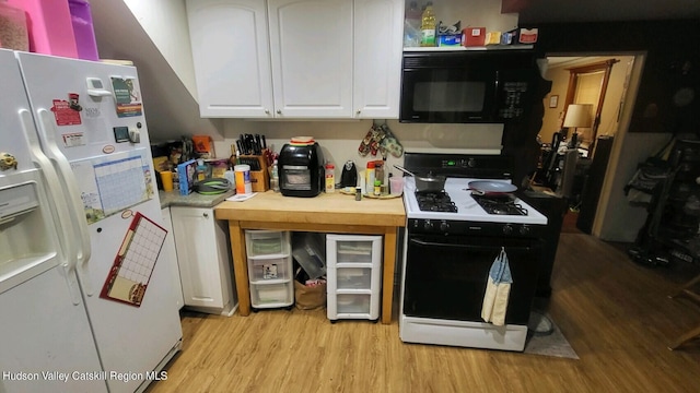 kitchen with white cabinets, white appliances, and light hardwood / wood-style flooring