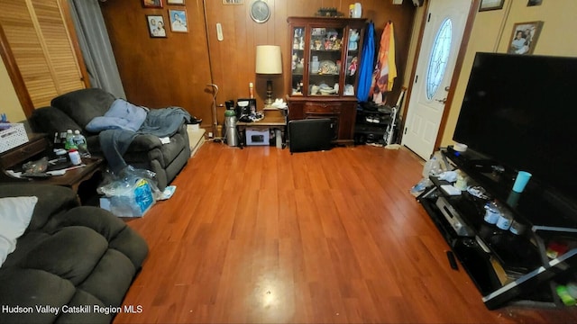 living room with wood-type flooring and wood walls