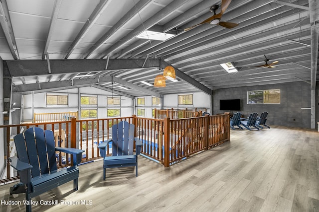 misc room with an upstairs landing, ceiling fan, a healthy amount of sunlight, and wood finished floors