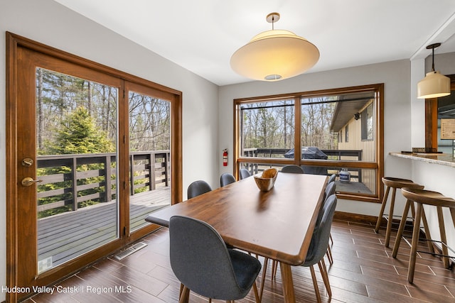 dining room with visible vents and dark wood finished floors