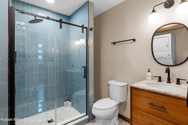 full bathroom with stacked washer / drying machine, toilet, vanity, and a stall shower