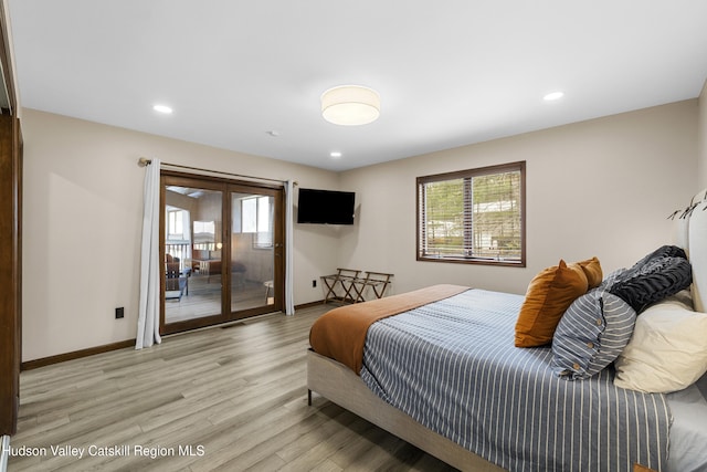 bedroom with light wood-type flooring, baseboards, access to outside, and french doors