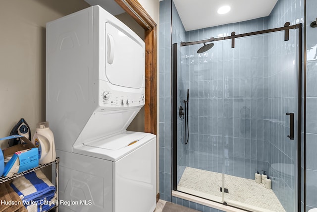 laundry room with stacked washer / dryer and laundry area