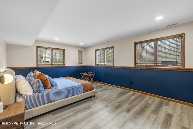 bedroom featuring baseboards, wood finished floors, visible vents, and recessed lighting