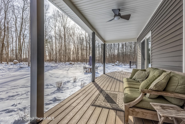 snow covered deck featuring ceiling fan