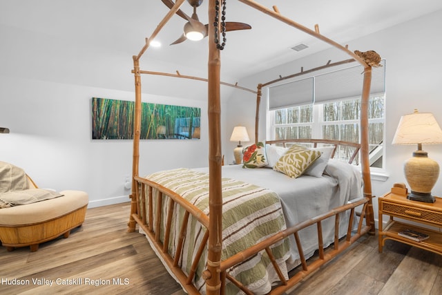 bedroom with hardwood / wood-style floors and ceiling fan