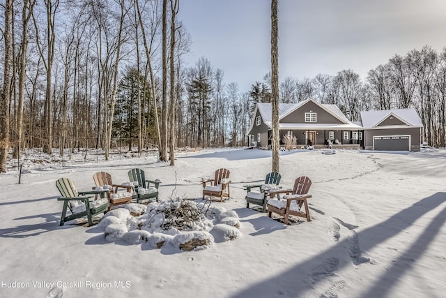 yard covered in snow featuring a garage