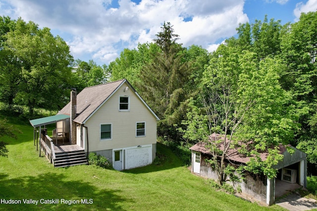 515 Delaware Ave, Andes, NY 13731 - view of home's exterior featuring a chimney, a wooden deck, and a lawn