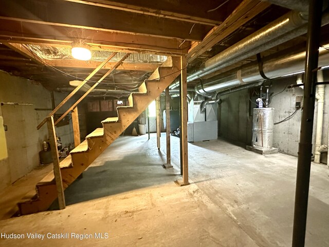 515 Delaware Ave, Andes, NY 13731 - unfinished basement with water heater, stairs, and heating unit