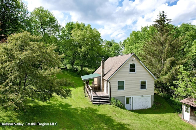 515 Delaware Ave, Andes, NY 13731 - back of property with a lawn, a chimney, a wooden deck, and a garage