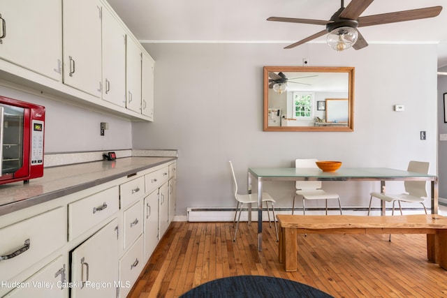 3271 Rte 212, Bearsville, NY 12409 - kitchen featuring hardwood / wood-style flooring, white cabinetry, baseboards, baseboard heating, and breakfast area