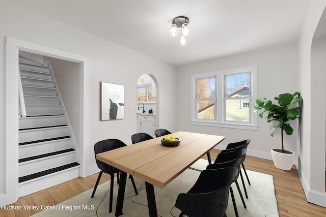 dining room featuring light hardwood / wood-style floors and sink