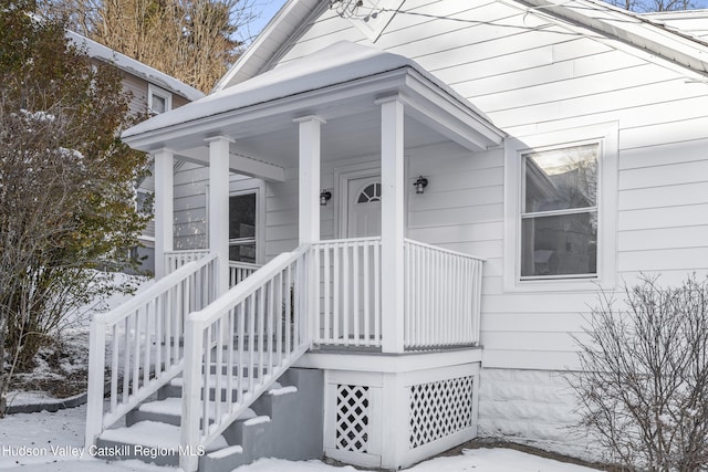 view of snow covered property entrance