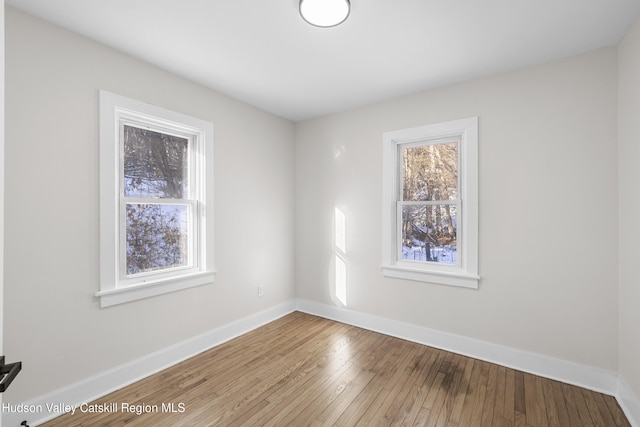 spare room with light hardwood / wood-style floors