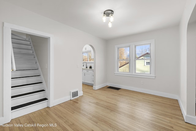 interior space featuring sink and light hardwood / wood-style flooring