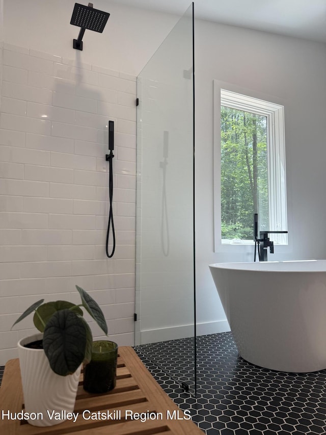 377 Pennsylvania Ave, Palenville, NY 12463 - full bathroom featuring a tile shower, a soaking tub, and tile patterned flooring